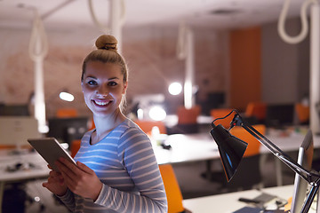 Image showing woman working on digital tablet in night office