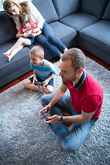 Image showing Happy family playing a video game