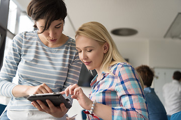 Image showing Pretty Businesswomen Using Tablet In Office Building during conf