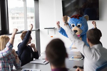 Image showing boss dresed as bear having fun with business people in trendy of