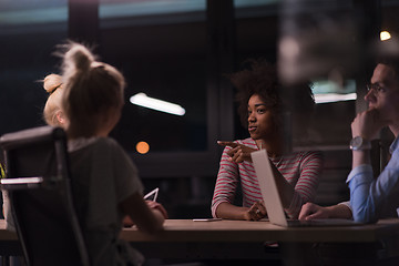 Image showing Multiethnic startup business team in night office