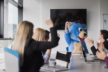 Image showing boss dresed as bear having fun with business people in trendy of