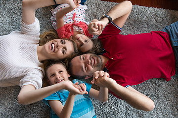 Image showing happy family lying on the floor