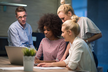 Image showing Multiethnic startup business team in night office