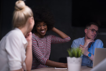 Image showing Multiethnic startup business team in night office