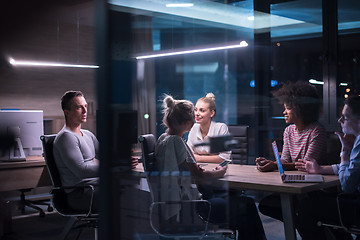 Image showing Multiethnic startup business team in night office