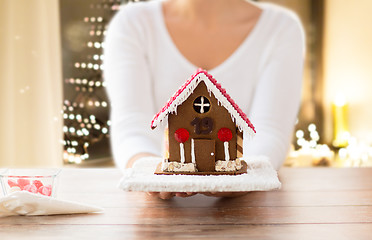 Image showing close up of woman with christmas gingerbread house