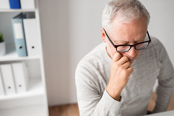 Image showing close up of senior man in glasses thinking