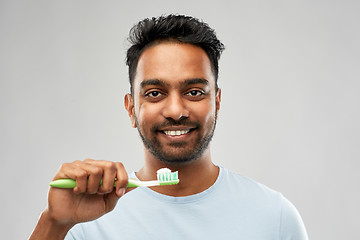 Image showing indian man with toothbrush over grey background