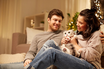 Image showing happy couple with cat at home