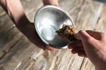 Image showing Male beggar hands seeking food or money at public path way