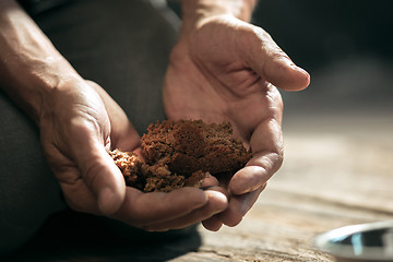 Image showing Male beggar hands seeking food or money at public path way