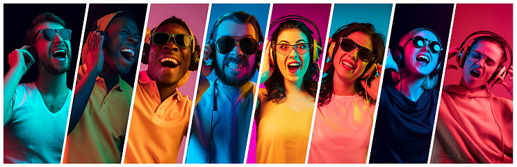 Image showing Beautiful young people in neon light isolated on multicolored studio background