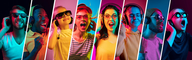 Image showing Beautiful young people in neon light isolated on multicolored studio background