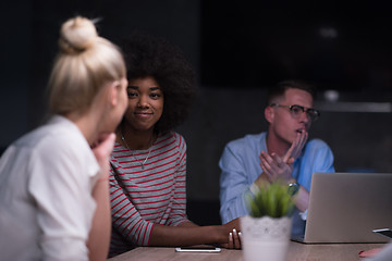 Image showing Multiethnic startup business team in night office