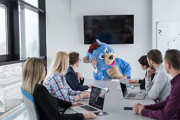 Image showing boss dresed as bear having fun with business people in trendy of