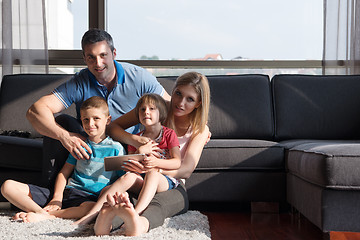 Image showing happy young couple spending time with kids