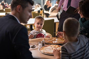 Image showing Young parents enjoying lunch time with their children