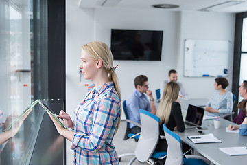 Image showing Pretty Businesswoman Using Tablet In Office Building by window