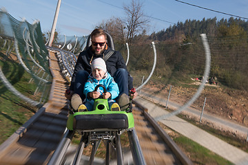 Image showing father and son enjoys driving on alpine coaster