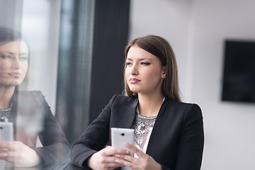 Image showing Business Girl Standing In A Modern Building Near The Window With