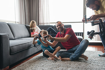 Image showing Happy family playing a video game