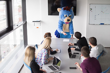 Image showing boss dresed as bear having fun with business people in trendy of