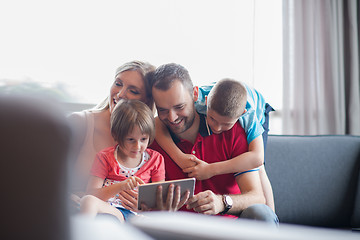 Image showing happy young couple spending time with kids