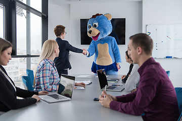 Image showing boss dresed as bear having fun with business people in trendy of