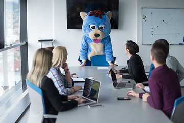 Image showing boss dresed as bear having fun with business people in trendy of