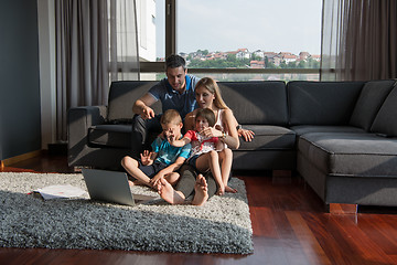 Image showing Family Playing Together with laptop computer