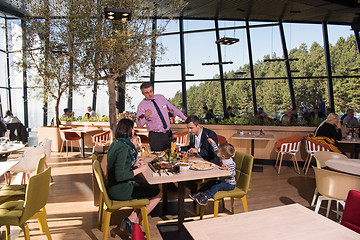 Image showing Young parents enjoying lunch time with their children