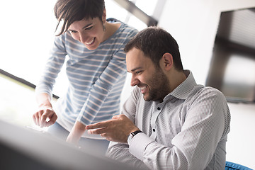 Image showing Two Business People Working With Tablet in startup office