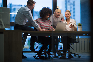 Image showing Multiethnic startup business team in night office