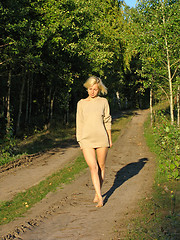 Image showing Girl wolking along the forest roud