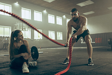 Image showing Men with battle rope battle ropes exercise in the fitness gym.