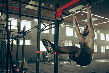 Image showing Concept: power, strength, healthy lifestyle, sport. Powerful attractive muscular man at CrossFit gym