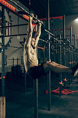 Image showing Concept: power, strength, healthy lifestyle, sport. Powerful attractive muscular man at CrossFit gym