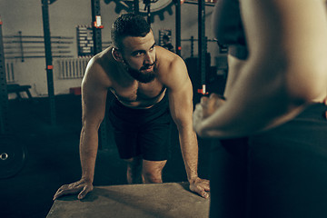 Image showing Man during exercises in the fitness gym. CrossFit.