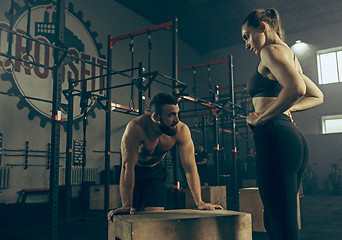 Image showing Man during exercises in the fitness gym. CrossFit.