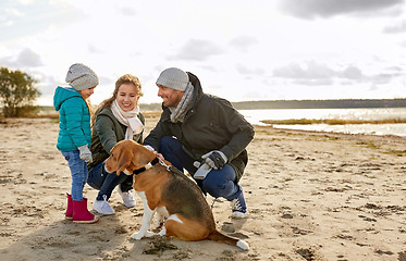 Image showing happy family with beagle dog on beach