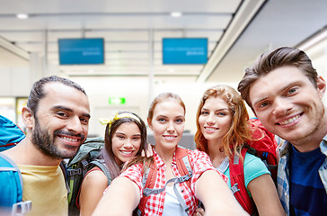 Image showing friends or tourists taking selfie over airport