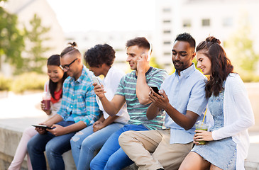 Image showing friends with smartphones hanging out in summer