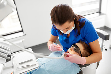 Image showing dentist checking for kid teeth at dental clinic