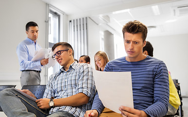 Image showing students with tests and teacher at lecture hall