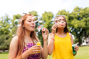 Image showing teenage girls blowing bubbles at summer park