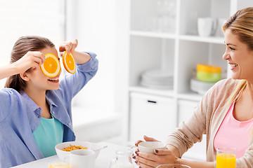 Image showing happy family having breakfast at home kitchen