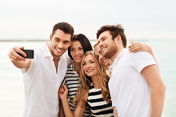 Image showing happy friends taking selfie on summer beach