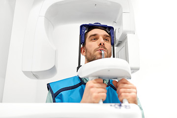 Image showing patient having x-ray scanning at dental clinic