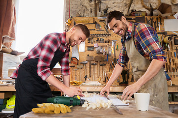 Image showing carpenters with ruler and blueprint at workshop